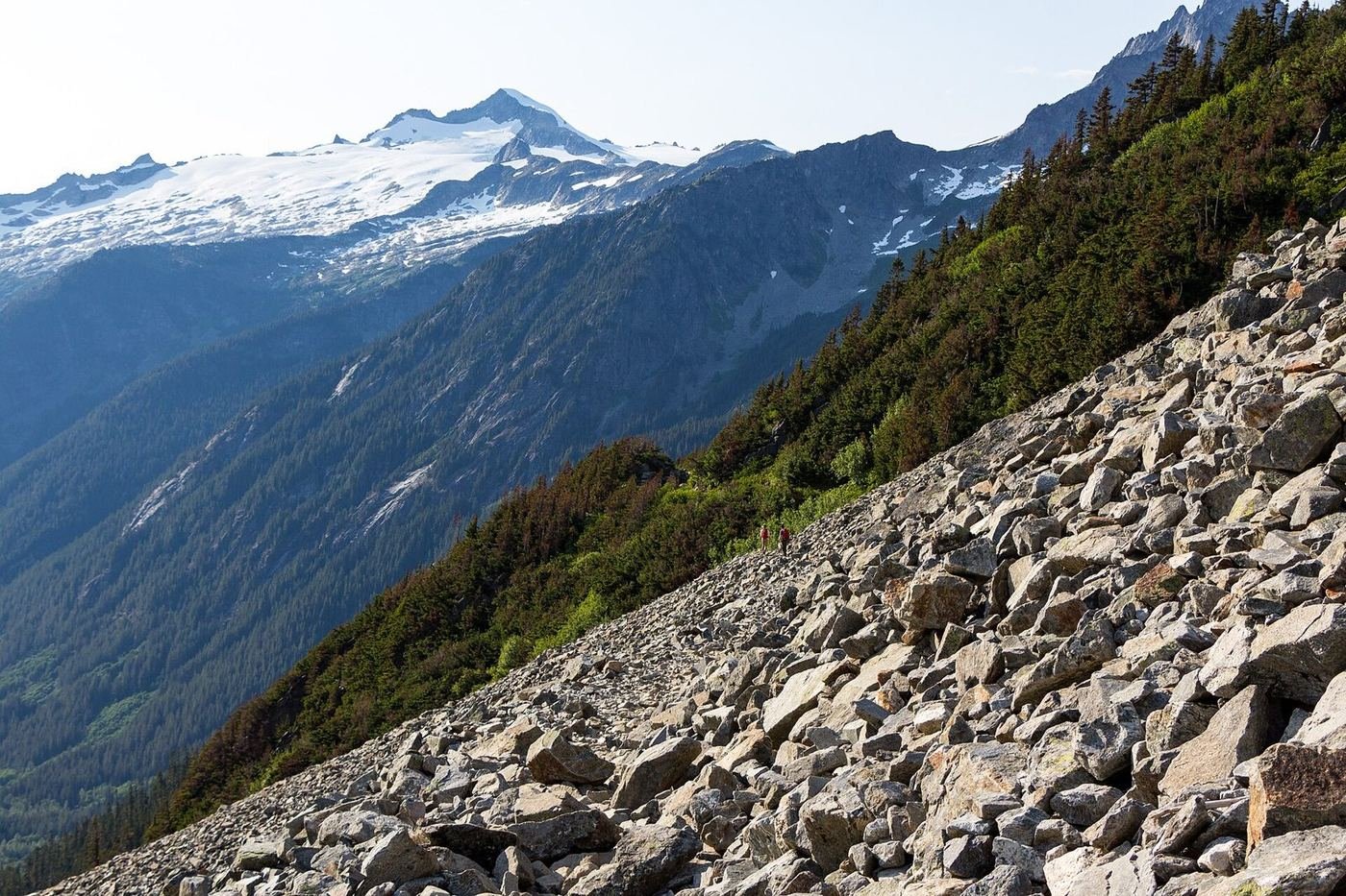 A snow-streaked peak rising above a talus slope in the North Cascades